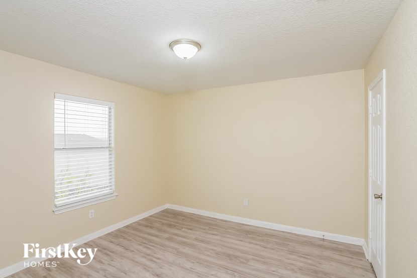 A room with a light brown floor and beige walls.