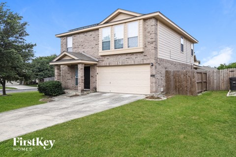 a brick house with a white garage door and a driveway