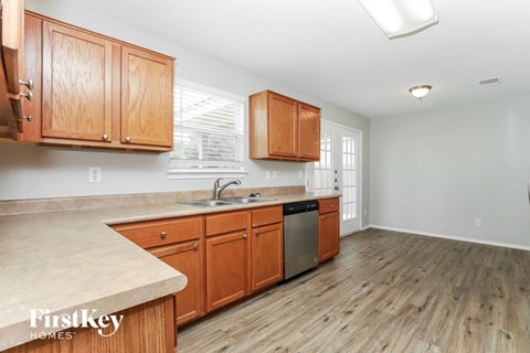 a kitchen with wooden cabinets and a sink and a dishwasher