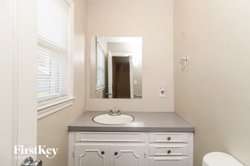 a small bathroom with a sink and a mirror