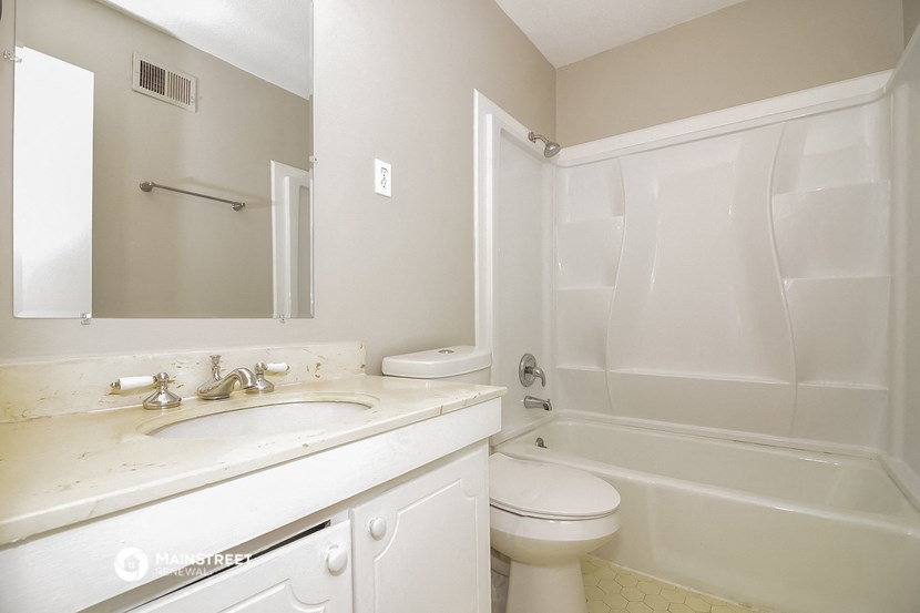 a bathroom with a sink toilet and a shower