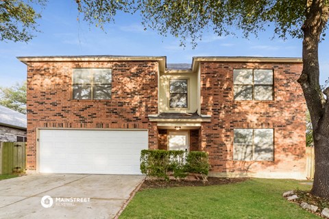 a brick house with a white garage door