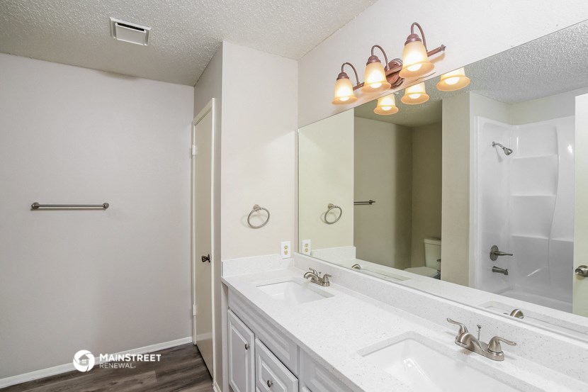 a bathroom with two sinks and a large mirror