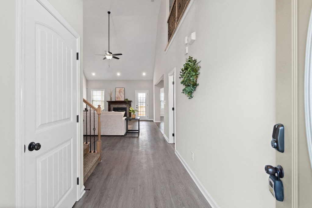 a long hallway with white walls and a white door