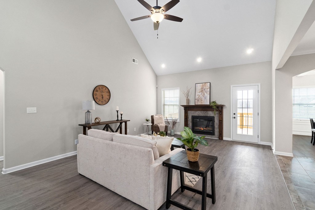 a living room with a couch and a ceiling fan