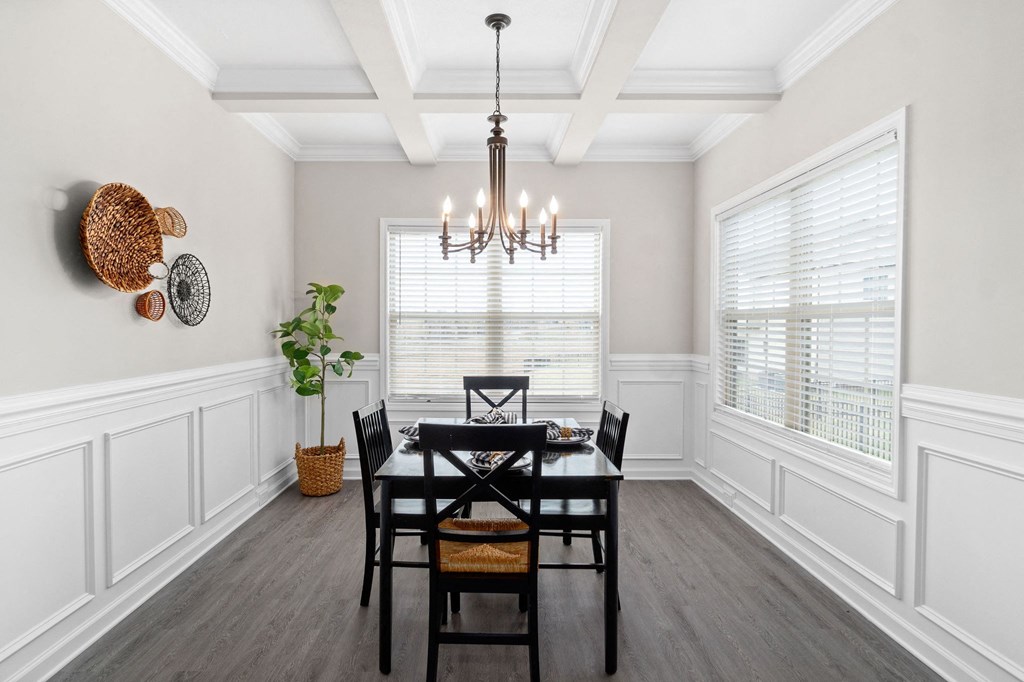 a dining room with a table and chairs and a chandelier