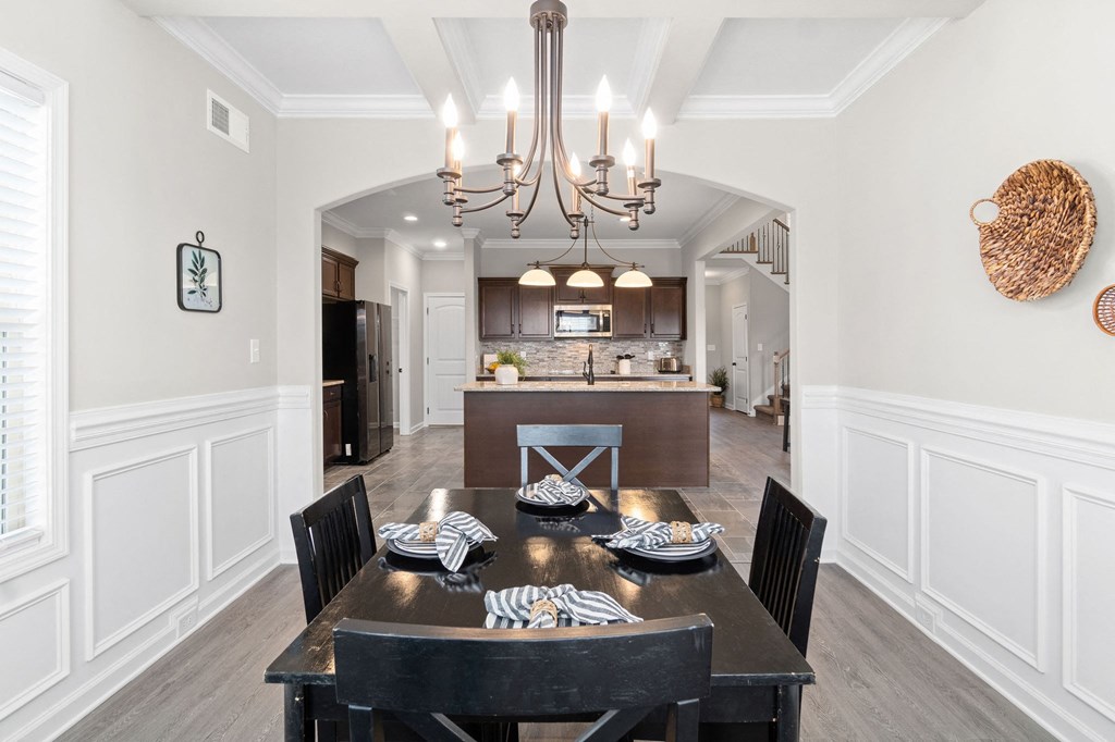 a dining room and kitchen with a table and chairs