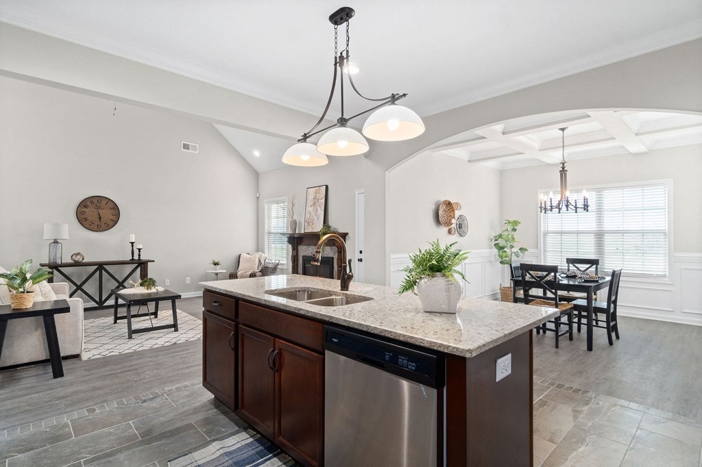 a kitchen with an island and a living room with a dining room