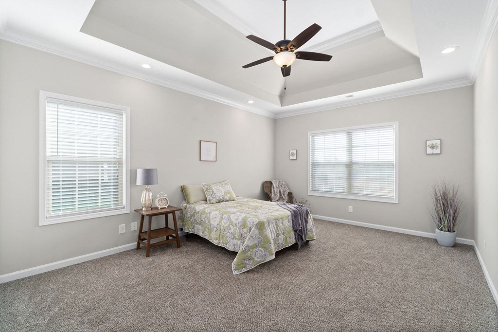 a bedroom with a bed and a ceiling fan