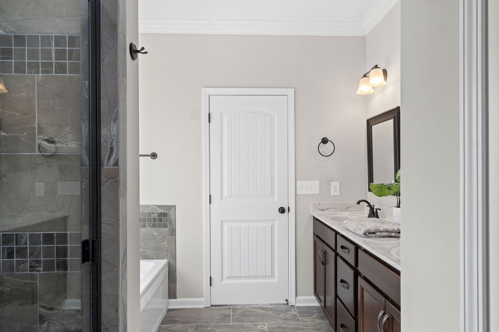 a bathroom with a shower and a sink and a mirror