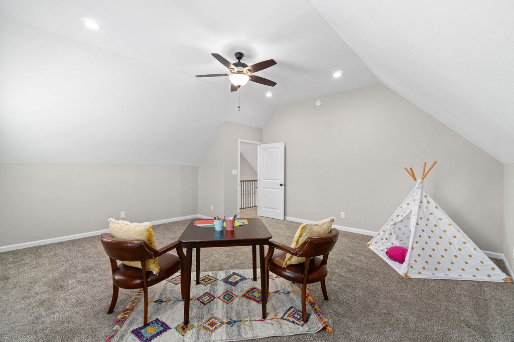a play room with a table and chairs and a toy tent