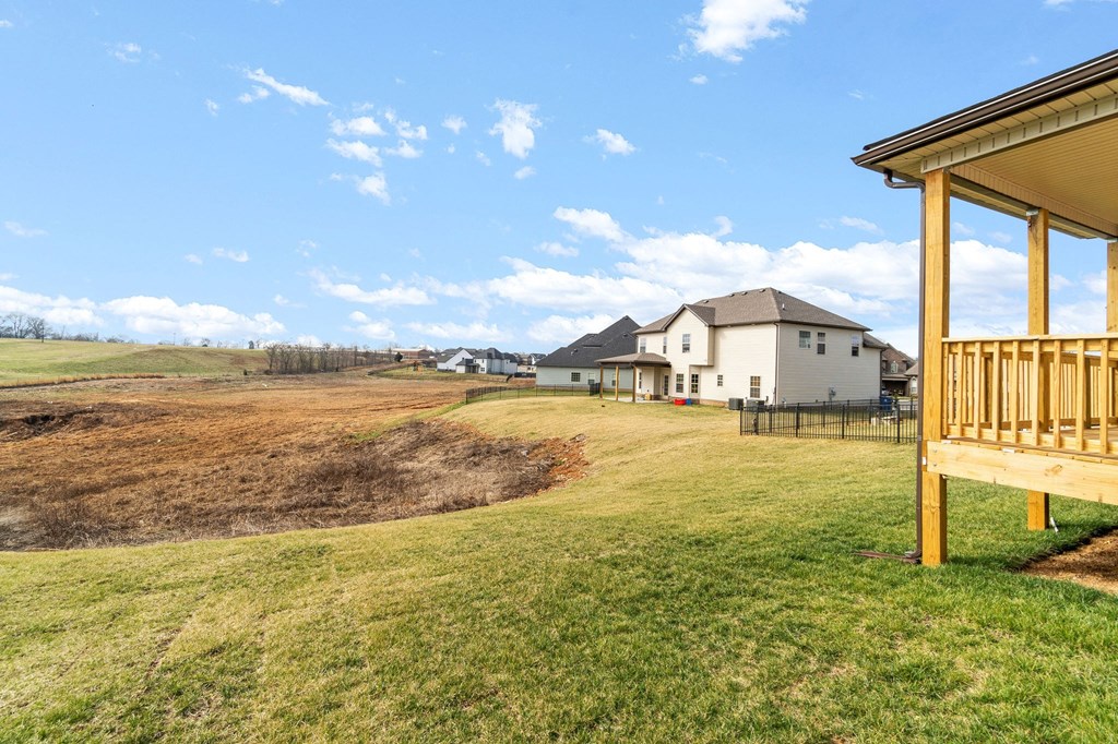 the view from the deck of a house on the side of a field