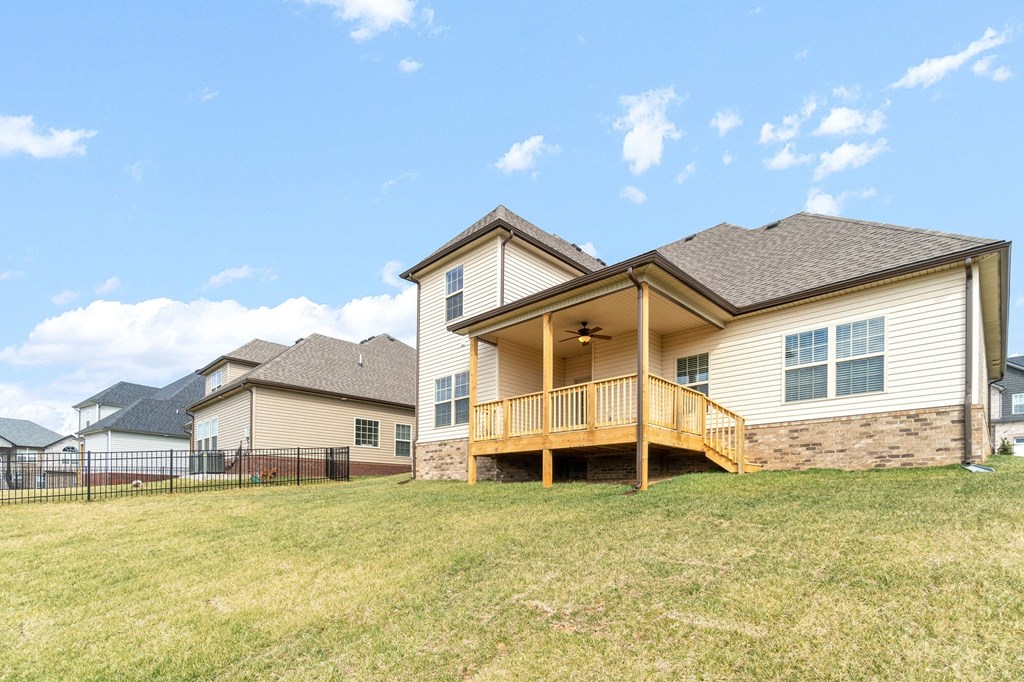 the backyard of a house with a yard and a deck