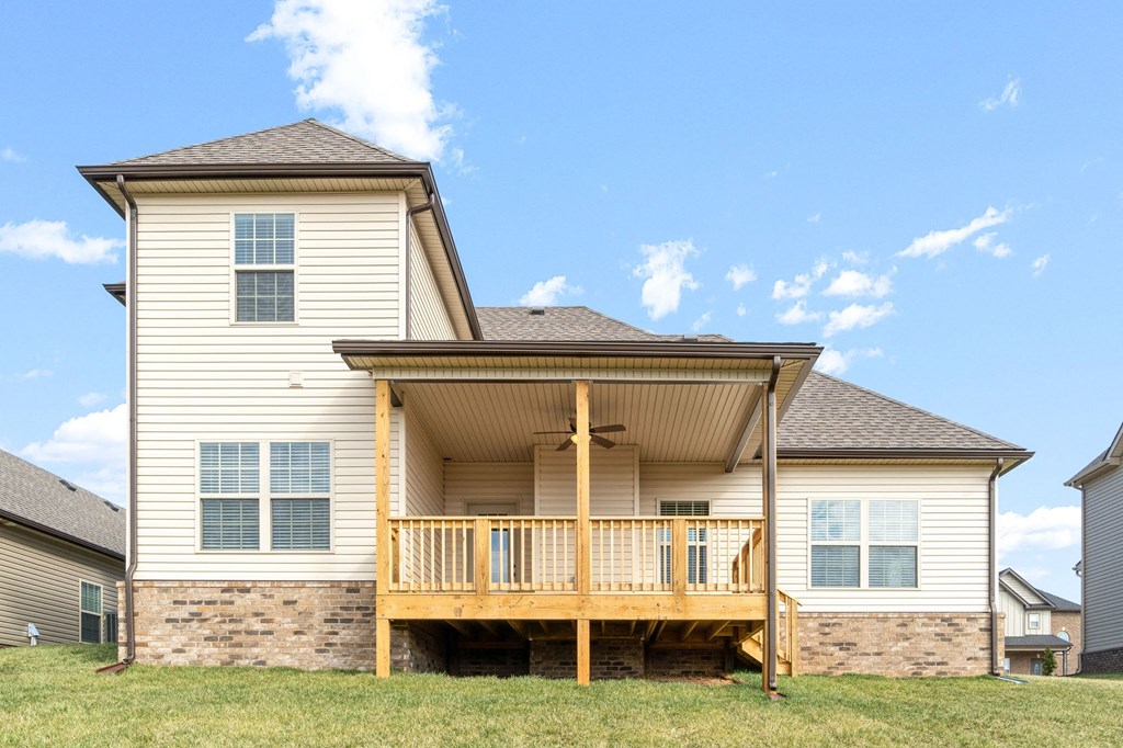 the back of a house with a deck and a porch