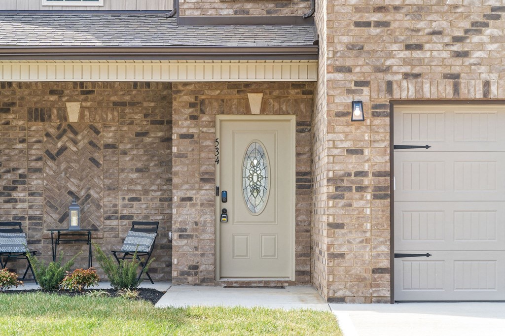 the front door of a brick house with a white door
