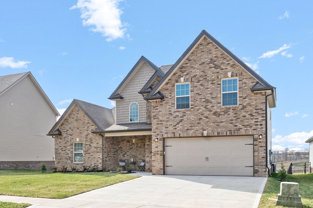 a large brick house with a garage and a driveway