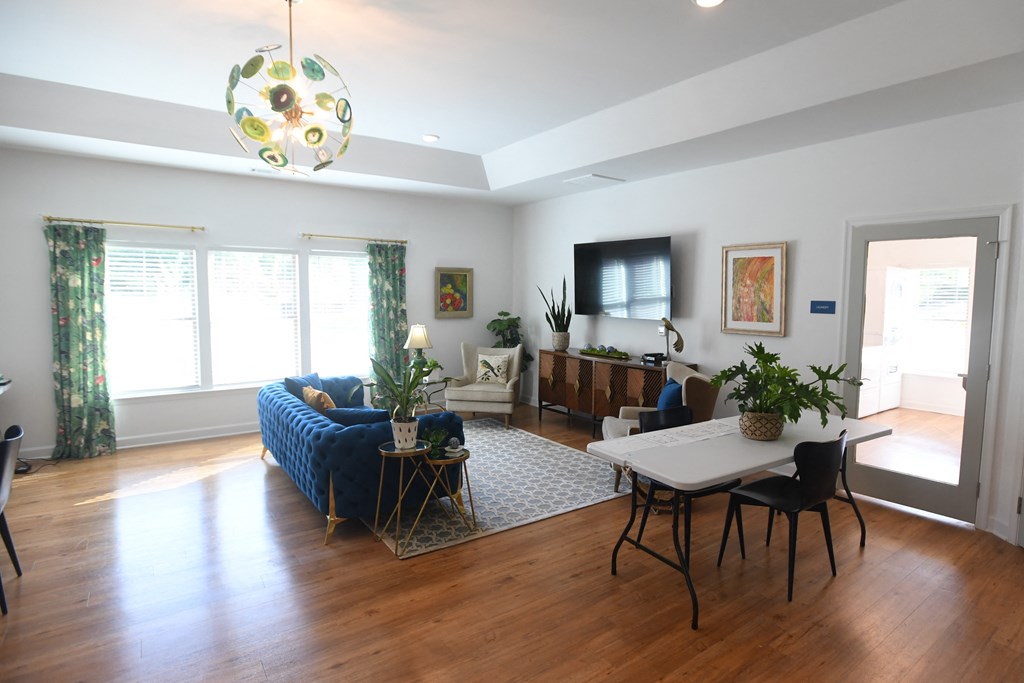 A living room with a blue couch and a white table.