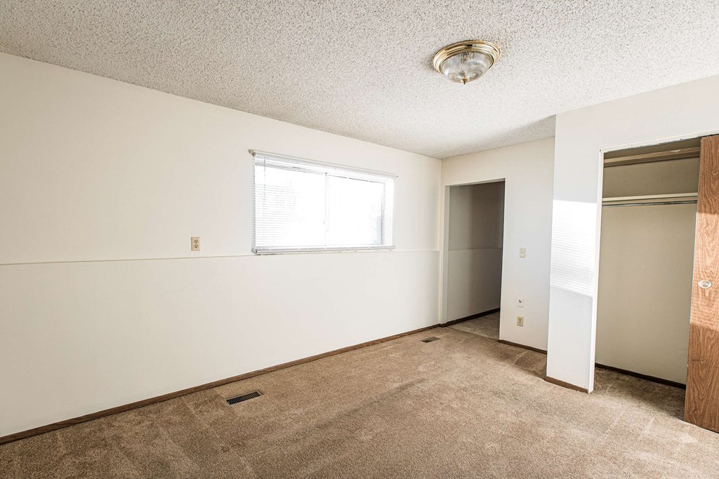 A room with a window and a door.