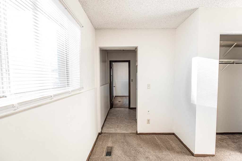 A white room with a doorway leading to another room.