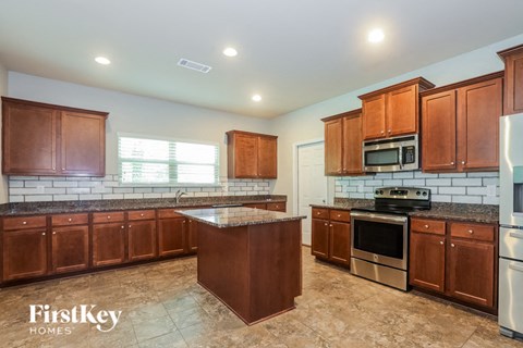 a kitchen with wooden cabinets and stainless steel appliances