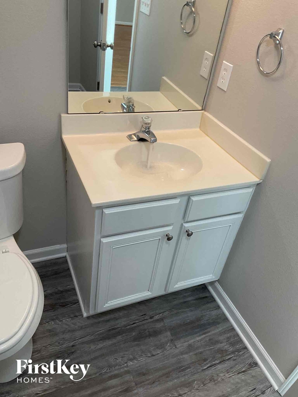 a bathroom with a sink and a mirror and a toilet