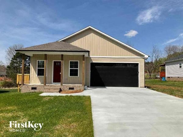 A two-car garage with a house attached is for sale.