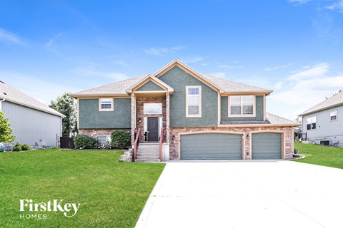 A house with a garage door is for sale.