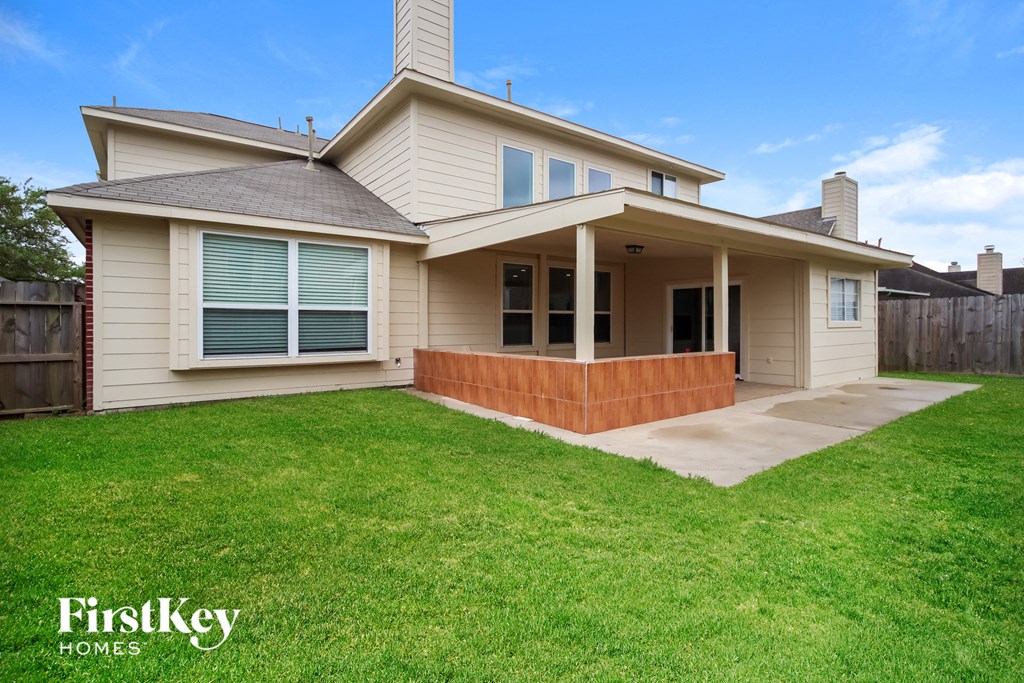 A house with a well-kept lawn in front of it.