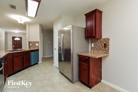 a kitchen with a stainless steel refrigerator and a counter top