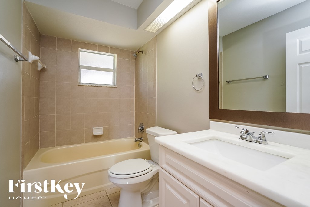 a bathroom with a toilet and a sink and a tub