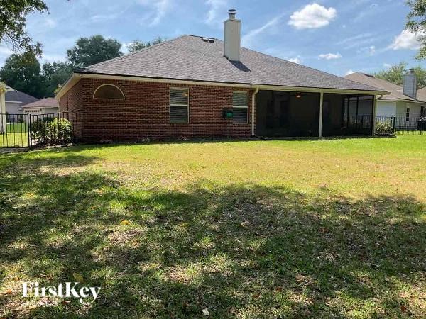 a small brick house with a yard in front of it