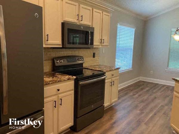a kitchen with a stove and a microwave