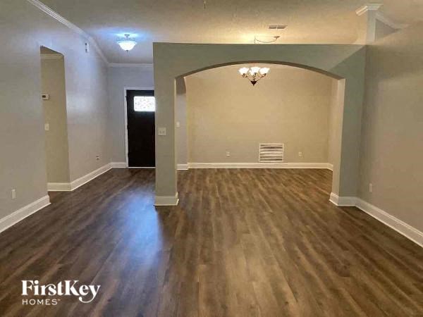 an empty living room with a hard wood floor