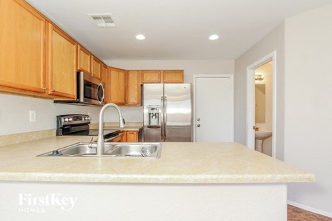 a kitchen with a sink and a refrigerator