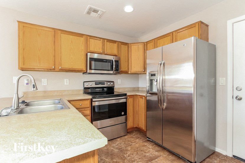 a kitchen with stainless steel appliances and wooden cabinets