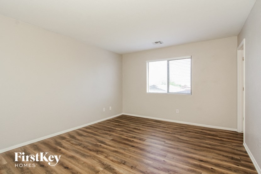 a living room with a window and wooden floors