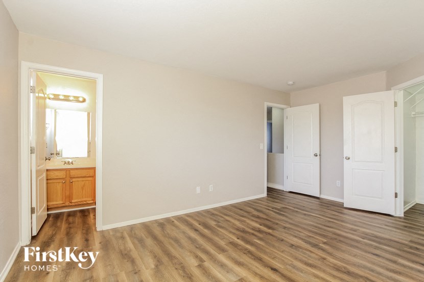 an empty living room with white walls and wood flooring