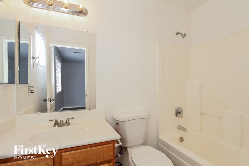 a bathroom with a toilet and a sink and a bath tub