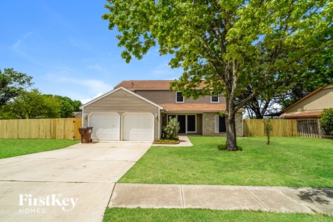 a house with a yard and a white garage door