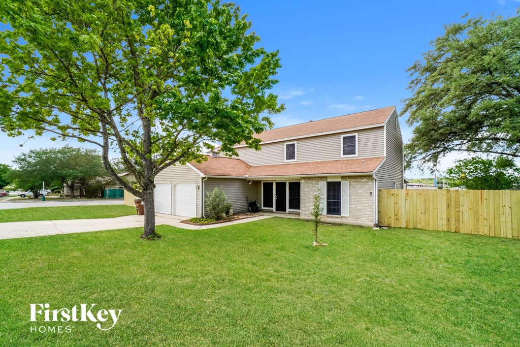 a house with a yard and a wooden fence