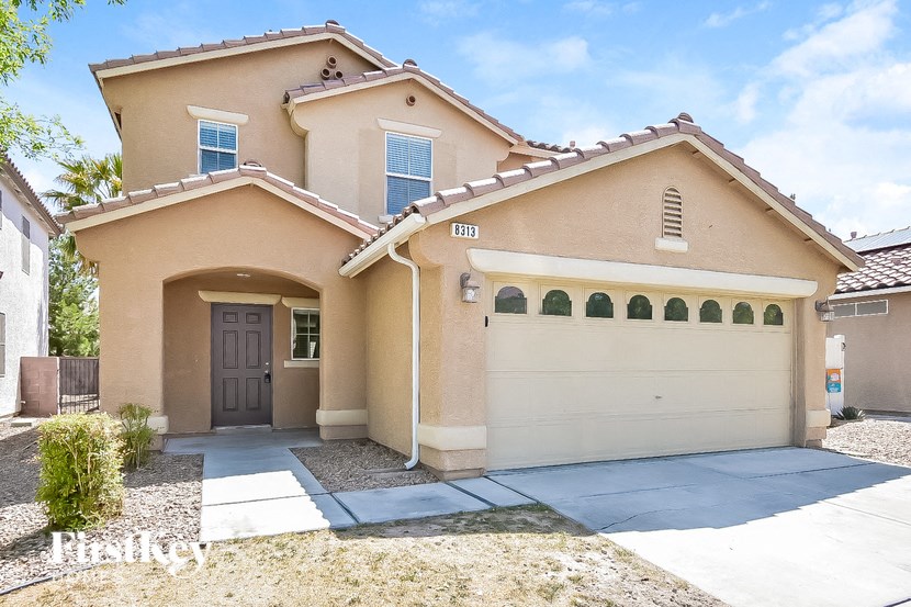 A two-story house with a garage and a driveway.