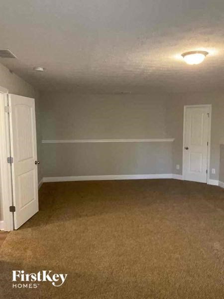 an empty room with a door and a white closet