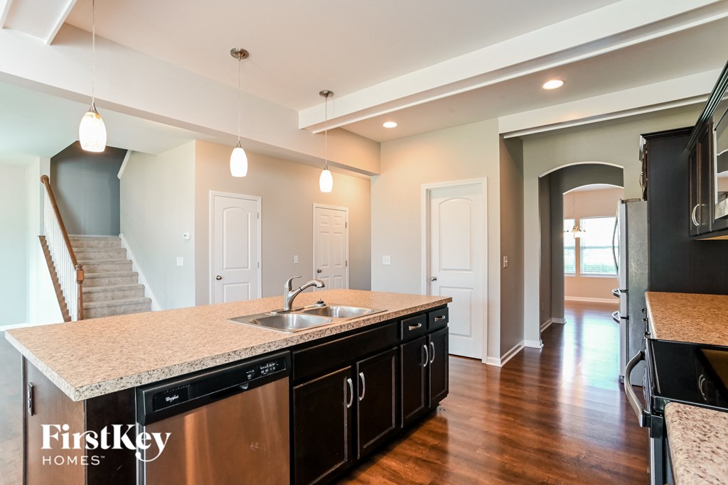a kitchen with granite counter tops and a stainless steel sink