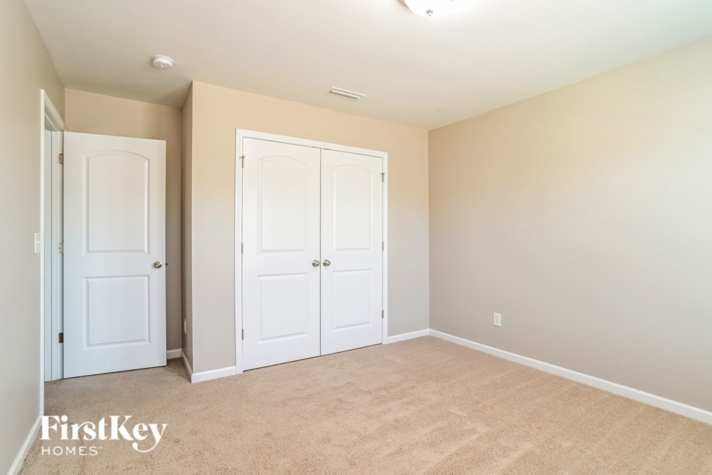 a bedroom with two closets and two doors