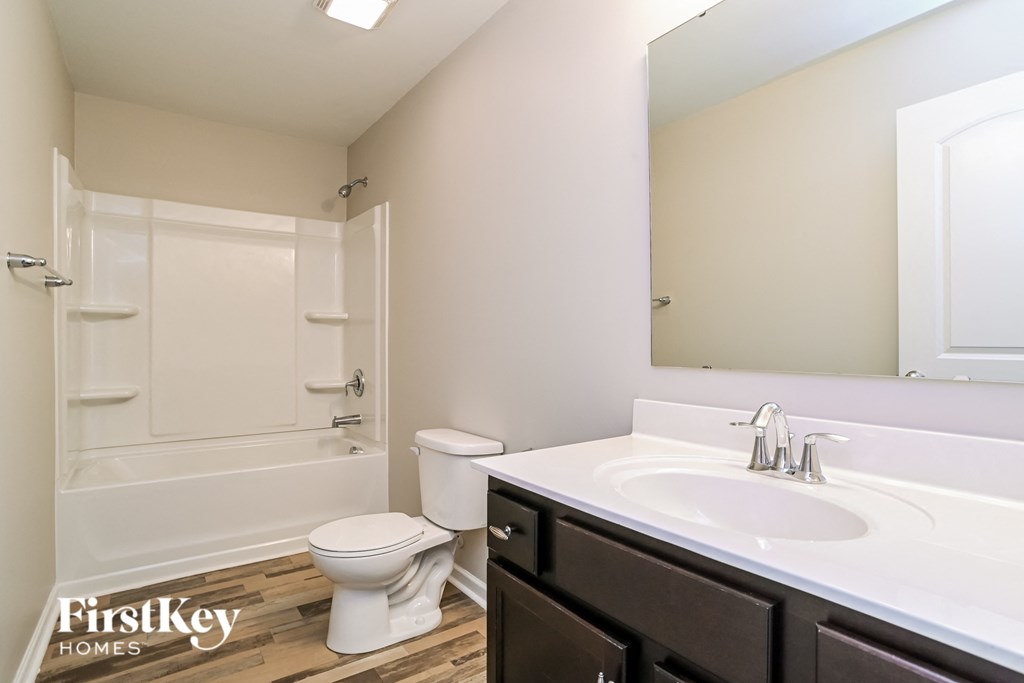 a bathroom with a sink and a toilet and a shower