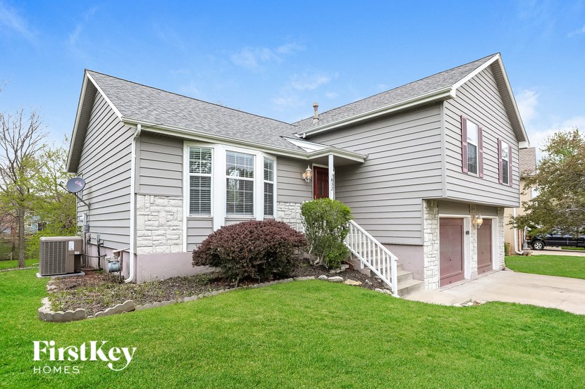 a white house with a lawn and a driveway