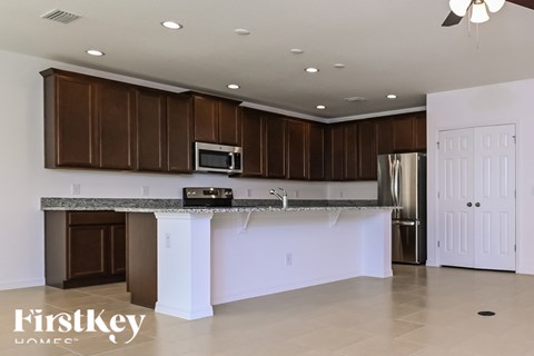 A kitchen with brown cabinets and a white island.
