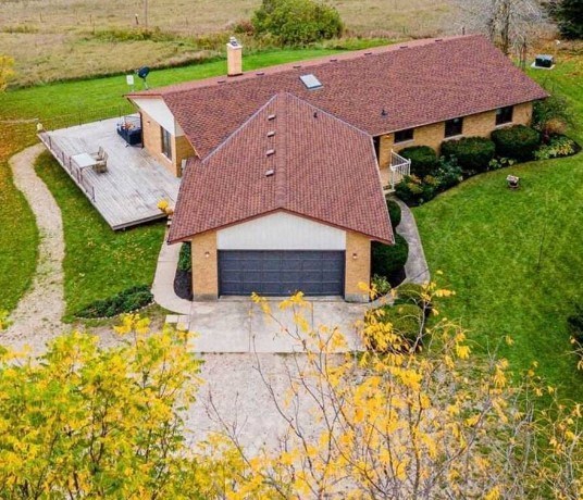 A house with a red tiled roof and a garage.