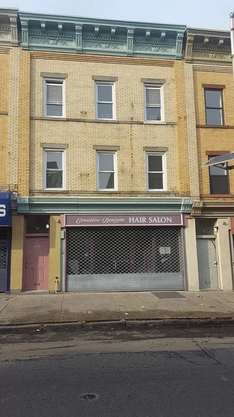 the front of a hair salon on a city street