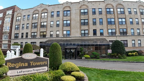 Regina Towers is a large building with a sign in front of it.